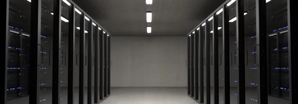 Hallway lined by computer servers.